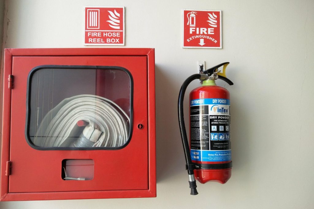 material de proteccion contra incendios en edificio. Un extintor y una caja contra incendios